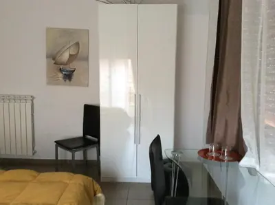 a bedroom with a bed and a glass table at Vado Al Massimo in Palermo