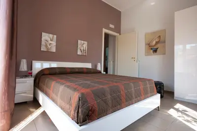 a bedroom with a large bed with a red blanket at Vado Al Massimo in Palermo