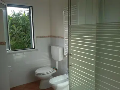 a bathroom with a toilet and a window at Principessa Jolanda in Mondello