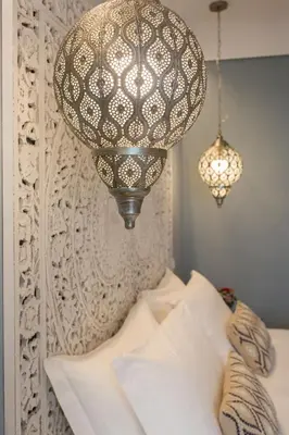a bedroom with a bed and a chandelier at Bellaroto Suite & Spa - Charming Boutique Rooms in Palermo