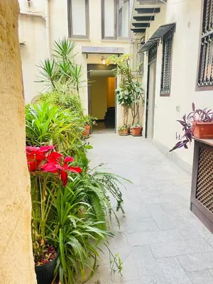 a courtyard with plants and flowers in a building at Bellaroto Suite & Spa - Charming Boutique Rooms in Palermo