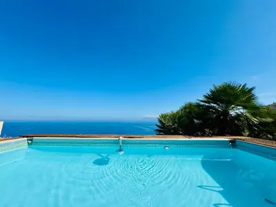 a swimming pool with a view of the ocean at Baglio La Luna - B&B in San Vito lo Capo