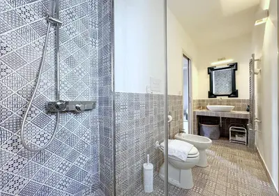 a bathroom with a shower and a toilet and a sink at Solemar Sicilia - Valuan Luxury Home in Palermo