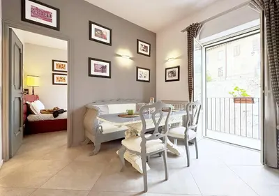 a dining room with a table and chairs and a bedroom at Solemar Sicilia - Valuan Luxury Home in Palermo