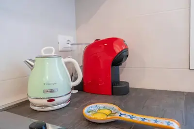 a kitchen counter with a tea kettle and a snake coaster at Villa Indipendente Jacuzzi Giardino Clima WiFi in Castellammare del Golfo