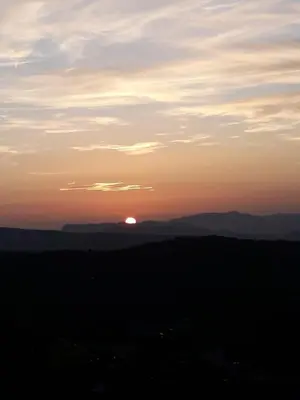 a sunset with the sun setting in the distance at La casa di Bia in Corleone