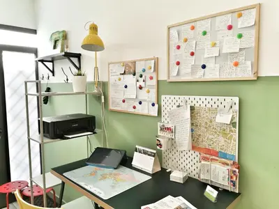 a office with a desk and a map on the wall at A Palermo Sono in Palermo