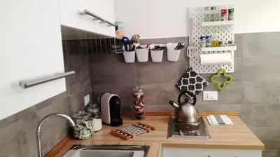 a small kitchen with a sink and a counter at A Palermo Sono in Palermo