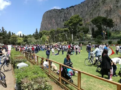 a large crowd of people standing around in a field at A Palermo Sono in Palermo