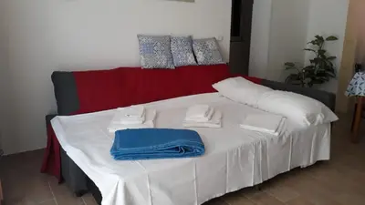 a bed with white and blue towels on it at Terrazza New Homes in Castellammare del Golfo