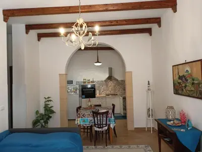 a living room with a blue couch and a table at Terrazza New Homes in Castellammare del Golfo