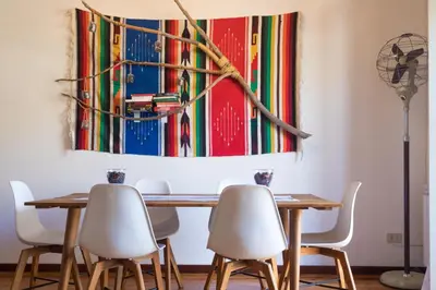 a living room with a blue couch and a table at Large terrace apartment near Politeama in Palermo