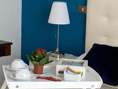 a white coffee table with a lamp on top of a bed at Apartment in the center in Terrasini