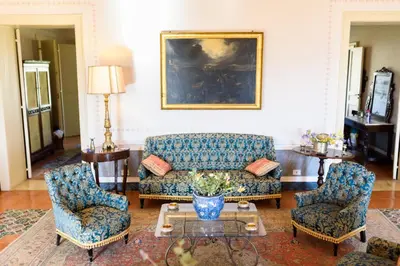 a living room with a couch and two chairs at Masseria Rossella in Piana degli Albanesi