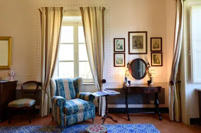 a room with a chair and a table and a window at Masseria Rossella in Piana degli Albanesi