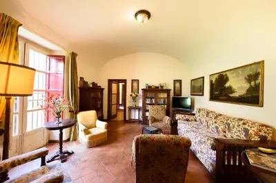 a living room with a couch and a tv at Masseria Rossella in Piana degli Albanesi