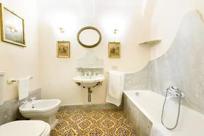 a bathroom with a toilet and a sink and a tub at Masseria Rossella in Piana degli Albanesi