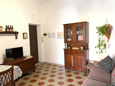a living room with a couch and a tv at Casa Arenella appartamento con parcheggio privato in Palermo