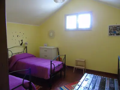 a bedroom with two beds and a window at Casa Arenella appartamento con parcheggio privato in Palermo