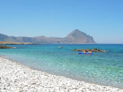 a group of people in a boat in the water at VILLA TREROSE by Trerose Properties - Villa centrale con wi-fi e posto auto privato gratuiti in San Vito lo Capo