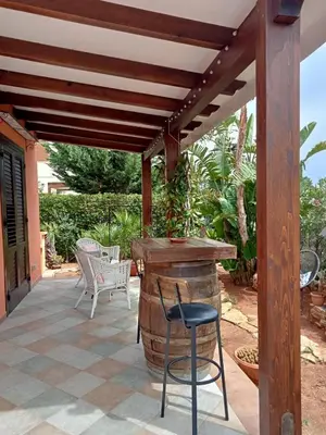 a patio with a bar and a wooden pergola at VILLA TREROSE by Trerose Properties - Villa centrale con wi-fi e posto auto privato gratuiti in San Vito lo Capo