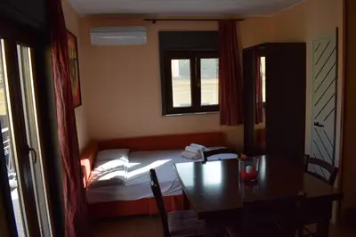 a room with a bed and a table and a window at Casa Gagà in Sferracavallo