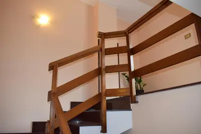 a staircase in a house with wooden railings at Casa Gagà in Sferracavallo