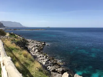a body of water with rocks and blue water at Casa Gagà in Sferracavallo
