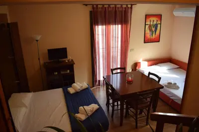 a hotel room with a bed and a table and a bedroom at Casa Gagà in Sferracavallo