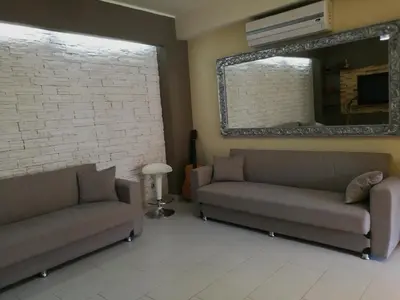 a living room with two couches and a mirror at Casa Valeria in Balestrate