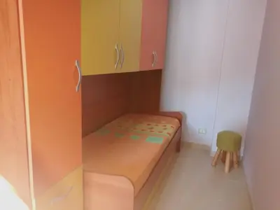 a small room with a bed and cabinets at Casa Valeria in Balestrate