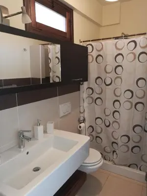 a bathroom with a sink and a toilet and a shower at Casa Valeria in Balestrate