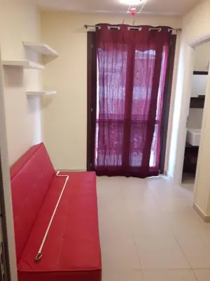 a red couch in a room with a window at Casa Valeria in Balestrate