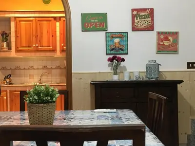 a kitchen with a table with a potted plant on it at La Casetta di Andrea & Vale in Termini Imerese