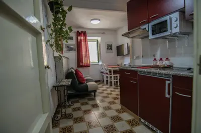 a small kitchen with a couch and a table at Vivere la Ciambra in Monreale