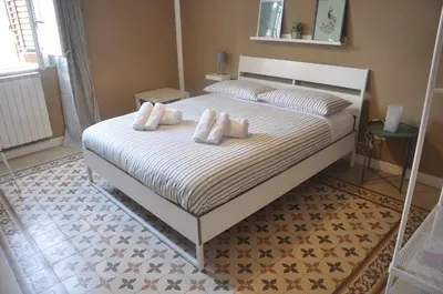 a bed with white pillows on it in a bedroom at Jennys place in Palermo