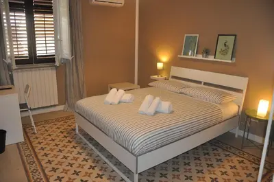 a bedroom with a bed with two pillows at Jennys place in Palermo