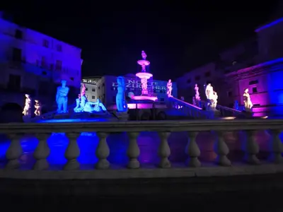 a fountain lit up in blue and purple at night at Casa4Casa in Palermo