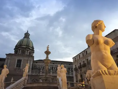a statue in front of a building with a dome at Casa4Casa in Palermo