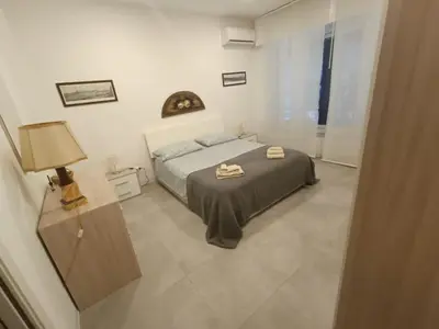 a bedroom with a bed with two towels on it at Casa4Casa in Palermo