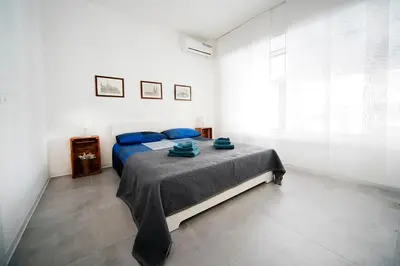 a bedroom with a blue bed and a window at Casa4Casa in Palermo