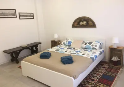 a bedroom with a bed with two blue towels on it at Casa4Casa in Palermo
