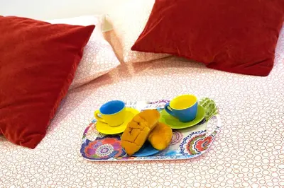a plate with two cups and saucers on a bed at Casa4Casa in Palermo