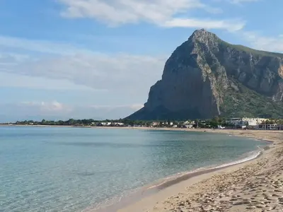 a view of a beach with a mountain in the background at Il Mulino in San Vito lo Capo