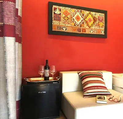 a room with a couch and a table with wine glasses at Locanda Sette Fate SPA e Solarium in Palermo