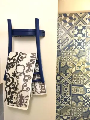 a towel rack with tiles on the wall and a towel at Locanda Sette Fate SPA e Solarium in Palermo
