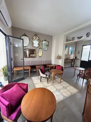 a living room with a purple couch and tables at Locanda Sette Fate SPA e Solarium in Palermo