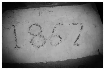 two numbers on a wall with writing on it at Agriturismo Sant'Agata in Piana degli Albanesi