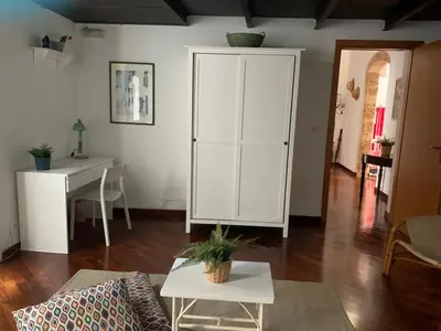 a living room with a white cabinet and a table at Casa Tea: nel cuore del centro storico in Palermo