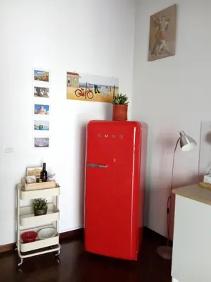 an old red refrigerator in a corner of a room at Casa Tea: nel cuore del centro storico in Palermo